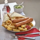 Sausages served with chips, peas and bread